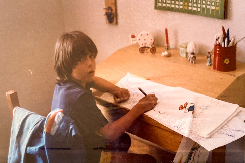 A photograph of me drawing as a child, by my dad Peter Griffee.